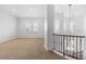 Spacious bonus room featuring a carpeted floor, bright windows, and modern light fixtures at 7882 Vallagio Ln, Englewood, CO 80112