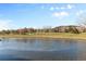 Peaceful view of a frozen pond with community buildings in the background at 7882 Vallagio Ln, Englewood, CO 80112