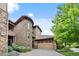Elegant stone townhouse with a two-car garage and beautiful landscaping at 7882 Vallagio Ln, Englewood, CO 80112