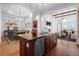 A modern, open concept kitchen with stainless steel appliances and a large central island at 7882 Vallagio Ln, Englewood, CO 80112