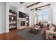 Bright living room with fireplace, wood beams and large windows offering natural light at 7882 Vallagio Ln, Englewood, CO 80112