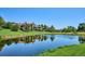 Scenic view of a tranquil pond reflecting nearby residential buildings and lush greenery on a sunny day at 7882 Vallagio Ln, Englewood, CO 80112