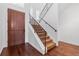 Elegant staircase with wrought iron railing and hardwood floors at 7882 Vallagio Ln, Englewood, CO 80112