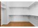 Large walk-in closet with ample shelving at 7882 Vallagio Ln, Englewood, CO 80112