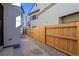 Small fenced backyard featuring a gravel area and concrete pathway at 1727 Lowell Blvd, Denver, CO 80204