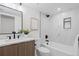 Updated bathroom featuring stylish vanity, a modern toilet, and shower over tub combo at 1727 Lowell Blvd, Denver, CO 80204