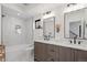 Modern bathroom with double vanity, soaking tub with marble-like tiling, and sleek fixtures at 1727 Lowell Blvd, Denver, CO 80204