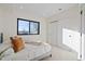 Bright bedroom with large window, plush carpet, and closet with sliding doors at 1727 Lowell Blvd, Denver, CO 80204