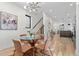 Open-concept dining room with a glass table, hardwood floors, and seamless flow to the living area at 1727 Lowell Blvd, Denver, CO 80204