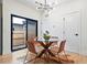 Bright dining room features modern lighting, hardwood floors and sliding glass door to the outdoors at 1727 Lowell Blvd, Denver, CO 80204