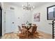 Bright dining area showcases hardwood floors, modern chandelier, and a stylish round table at 1727 Lowell Blvd, Denver, CO 80204