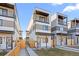 Modern townhome with balconies, stylish color palette, and inviting walkway to the front door at 1727 Lowell Blvd, Denver, CO 80204