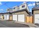 A row of detached garages with white doors and modern architectural details at 1727 Lowell Blvd, Denver, CO 80204