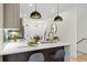 Stylish kitchen featuring an island with counter seating, modern pendant lights, and open to dining area at 1727 Lowell Blvd, Denver, CO 80204