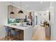 Modern kitchen with a large island, stainless steel appliances, and a view into the dining area at 1727 Lowell Blvd, Denver, CO 80204