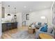 Bright living room open to kitchen features hardwood floors, contemporary furnishings, and recessed lighting at 1727 Lowell Blvd, Denver, CO 80204