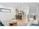 Open-concept living space flows seamlessly into the kitchen with hardwood floors and contemporary decor at 1727 Lowell Blvd, Denver, CO 80204