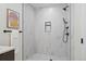 Modern walk-in shower featuring marble tiling and a black shower head and fixtures at 1727 Lowell Blvd, Denver, CO 80204