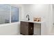 Basement wet bar featuring a sink, modern faucet, and a stylish wine rack at 1727 Lowell Blvd, Denver, CO 80204