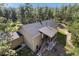 Aerial shot of a home with a covered patio, well maintained roof, and stairs leading to the entrance at 11044 Conestoga Pl, Franktown, CO 80116