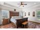 Bedroom with a wooden bed and bright natural light at 11044 Conestoga Pl, Franktown, CO 80116