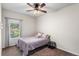 Cozy bedroom featuring a ceiling fan and a bright window with scenic outdoor views at 11044 Conestoga Pl, Franktown, CO 80116