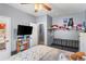 Bedroom with a sofa, TV, shelves, and decorations at 11044 Conestoga Pl, Franktown, CO 80116