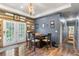 Dining area with wood floors, modern lighting, and access to the outdoors through French doors at 11044 Conestoga Pl, Franktown, CO 80116