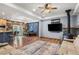 Open-concept living room featuring wood floors, a wood-burning stove, and modern decor at 11044 Conestoga Pl, Franktown, CO 80116