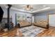 Cozy living room with a wood-burning stove, hardwood floors, and neutral-toned seating at 11044 Conestoga Pl, Franktown, CO 80116