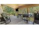 Spacious covered deck with outdoor furniture, a television, and a selection of grills at 11044 Conestoga Pl, Franktown, CO 80116