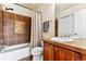 Cozy bathroom with a tub and shower combination, decorative tile accent, and a vanity with storage at 1997 Fox Haven Dr, Castle Rock, CO 80104