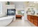 Bright, modern bathroom features a fireplace, soaking tub, and separate vanities with granite countertops at 1997 Fox Haven Dr, Castle Rock, CO 80104