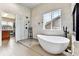 Modern bathroom with a luxurious soaking tub, frameless glass shower, and stylish tile work at 1997 Fox Haven Dr, Castle Rock, CO 80104
