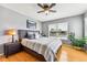 Cozy bedroom with a comfortable queen-sized bed, wood floors, and a large window for natural light at 1997 Fox Haven Dr, Castle Rock, CO 80104