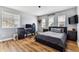 Bedroom with a modern setup: hardwood floors, a gaming desk, a comfortable bed and ample natural light at 1997 Fox Haven Dr, Castle Rock, CO 80104
