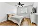 Comfortable bedroom with hardwood floors, a soft bed, and ample natural light from the window at 1997 Fox Haven Dr, Castle Rock, CO 80104