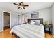 Comfortable bedroom features wood floors, a queen bed, nightstands, and a ceiling fan at 1997 Fox Haven Dr, Castle Rock, CO 80104
