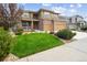 Beautifully landscaped front yard with a lush green lawn, decorative rocks, and mature trees creating great curb appeal at 1997 Fox Haven Dr, Castle Rock, CO 80104