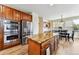 Spacious kitchen with stainless steel appliances, wood cabinets, granite countertops, and a large center island at 1997 Fox Haven Dr, Castle Rock, CO 80104