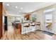 Eat-in kitchen with wood floors, countertops, breakfast bar, and stainless appliances offering ample space to cook and dine at 1997 Fox Haven Dr, Castle Rock, CO 80104