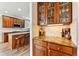 Butler's pantry with custom cabinets and a granite countertop, next to a well-appointed eat-in kitchen with wood floors at 1997 Fox Haven Dr, Castle Rock, CO 80104