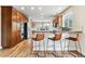 Open concept kitchen features stainless steel appliances, wood cabinets, and a breakfast bar for casual dining at 1997 Fox Haven Dr, Castle Rock, CO 80104