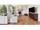 Bright living room featuring a stone fireplace, wood floors, and large sectional couch at 1997 Fox Haven Dr, Castle Rock, CO 80104