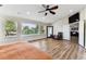 Sunlit main bedroom featuring wood flooring, high ceilings, and view of the outdoors at 1997 Fox Haven Dr, Castle Rock, CO 80104