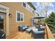 Comfortable outdoor patio with wicker seating, dining set, and wood deck at 1997 Fox Haven Dr, Castle Rock, CO 80104