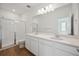 Bathroom featuring a vanity with dual sinks, white tile, and a glass door shower at 1224 Penner Dr, Erie, CO 80026