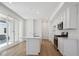 Modern kitchen features stainless appliances, large island, and slider to patio at 1224 Penner Dr, Erie, CO 80026