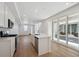 Spacious kitchen features white cabinetry, island, and stainless appliances at 1224 Penner Dr, Erie, CO 80026