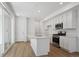 Modern kitchen features stainless appliances, large island, and slider to patio at 1224 Penner Dr, Erie, CO 80026